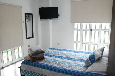 a bedroom with a bed with towels on it at Apartahotel Avverato in Guatapé