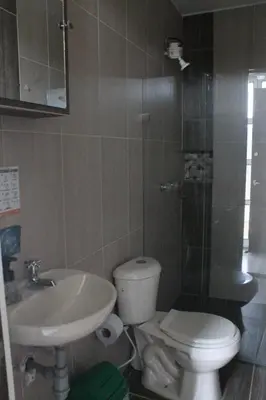 a bathroom with a toilet and a sink at Apartahotel Avverato in Guatapé