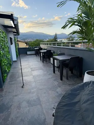 a patio with tables and chairs on a building at Nuevo cerca poblado 301 in Medellín