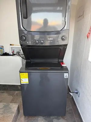 a microwave oven sitting on top of a refrigerator at Nuevo cerca poblado 301 in Medellín