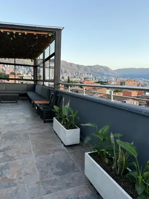 a balcony with benches and plants on a building at Nuevo cerca poblado 301 in Medellín
