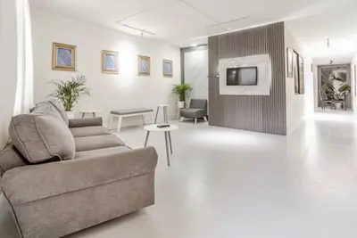 a living room with a couch and a tv at El Poblado 4 Bedroom 3 Bathroom private Terrace in Medellín