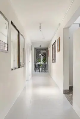 an empty hallway with white walls and a dining room at El Poblado 4 Bedroom 3 Bathroom private Terrace in Medellín