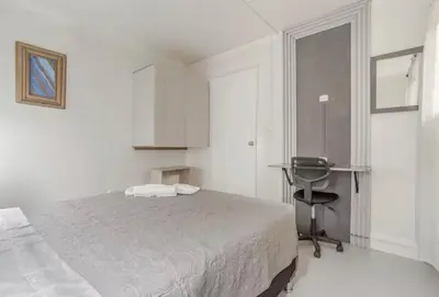 a bedroom with a bed and a desk and a chair at El Poblado 4 Bedroom 3 Bathroom private Terrace in Medellín