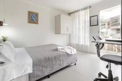 a bedroom with a bed and a desk and a table at El Poblado 4 Bedroom 3 Bathroom private Terrace in Medellín