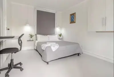a bedroom with a bed and a desk and a chair at El Poblado 4 Bedroom 3 Bathroom private Terrace in Medellín