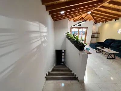 a stairway leading to a living room with a couch at Prosperity Room, Habitación doble - solo a una cuadra del parque in Carmen de Viboral