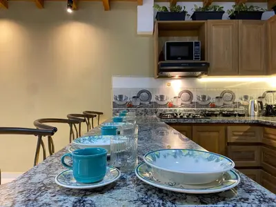 a kitchen with a counter with blue dishes on it at Prosperity Room, Habitación doble - solo a una cuadra del parque in Carmen de Viboral