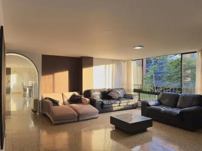 a living room with two couches and a table at 5BR 232 m² apartment in El Poblado, El Tesoro in Medellín