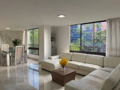 a living room with a couch and a table at 5BR 232 m² apartment in El Poblado, El Tesoro in Medellín