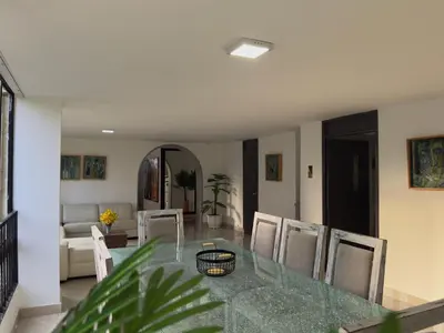 a dining room with a glass table and chairs at 5BR 232 m² apartment in El Poblado, El Tesoro in Medellín