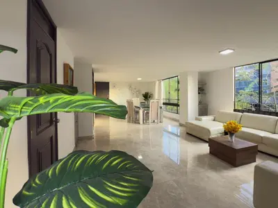 a large living room with a couch and a plant at 5BR 232 m² apartment in El Poblado, El Tesoro in Medellín