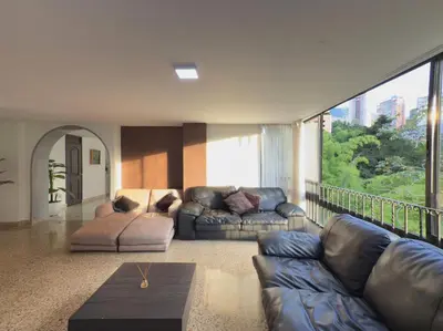 a living room with a couch and a table at 5BR 232 m² apartment in El Poblado, El Tesoro in Medellín