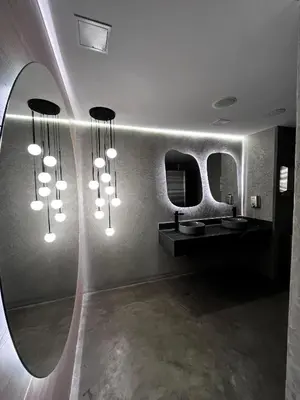a bathroom with a bunch of lights on the wall at Hotel Time Oclock in Medellín