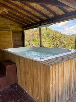 a large hot tub in a wooden building at Rancho Forest Guatape in Guatapé