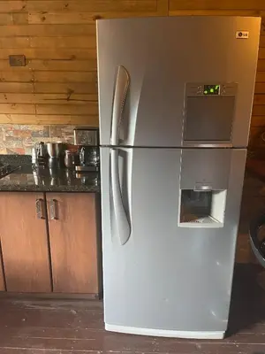a refrigerator with a microwave on top of it in a kitchen at Rancho Forest Guatape in Guatapé