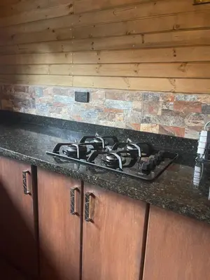 a stove top on a counter in a kitchen at Rancho Forest Guatape in Guatapé