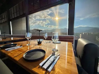 a wooden table with wine glasses and a view at Loft 203 Laureles Le meilleur emplacement WIFI Toit in Medellín