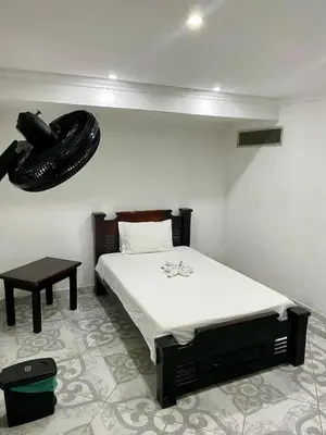 a bedroom with a bed and a phone on the wall at Habitación sencilla con desayuno - La Casona Hotel in La Pintada