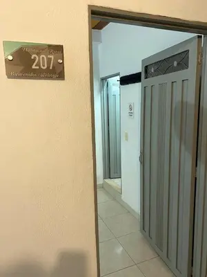 an entrance to a building with a sign on the wall at Habitación sencilla con desayuno - La Casona Hotel in La Pintada