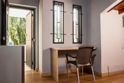 a dining room with a table and a chair at Hotel Casa 73 Deluxe in Medellín