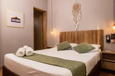 a bedroom with two beds with towels on them at Hotel Casa 73 Deluxe in Medellín