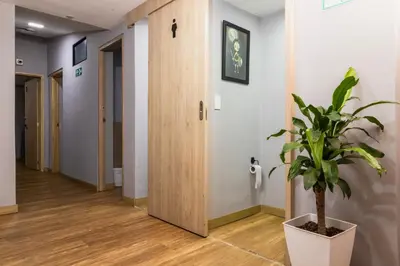 a hallway with a potted plant next to a door at Hotel Casa 73 Deluxe in Medellín