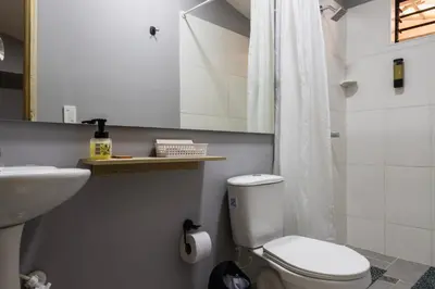 a bathroom with a white toilet and a sink at Hotel Casa 73 Deluxe in Medellín