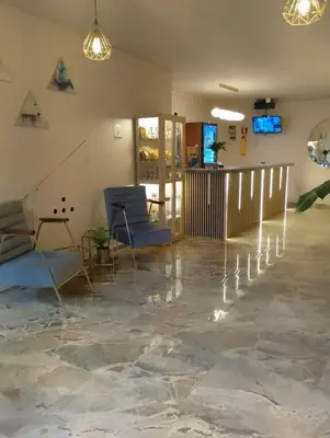 a lobby with chairs and lights on the floor at History Center Hotel in Medellín