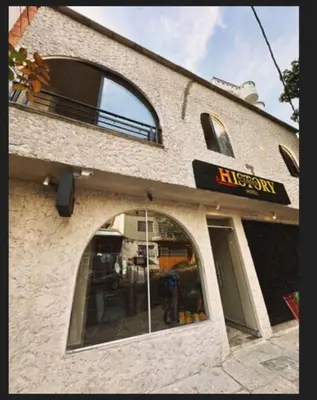 a building with an entrance to a pizza restaurant at History Center Hotel in Medellín