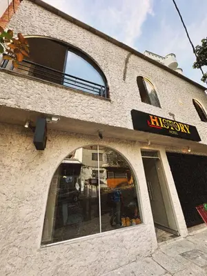 a brick building with an entrance to a restaurant at History Center Hotel in Medellín