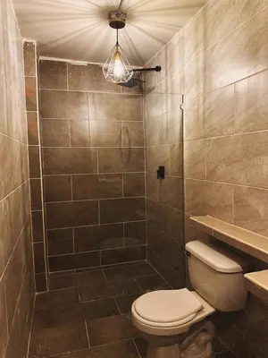 a bathroom with a toilet and a shower at History Center Hotel in Medellín