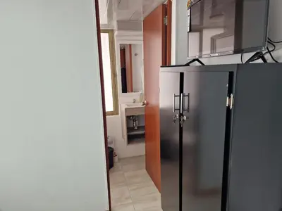 a kitchen with a stainless steel refrigerator in a room at Habitación baño privado garaje moto, Manizales in Manizales