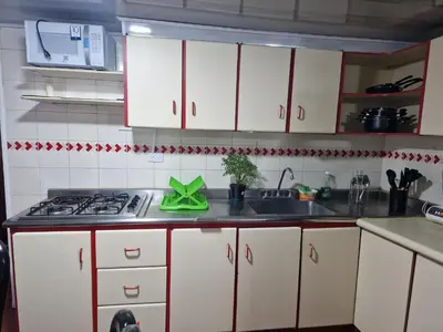 a kitchen with white cabinets and a sink at Habitación baño privado garaje moto, Manizales in Manizales