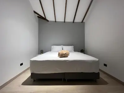 a bedroom with a bed with a stuffed animal on it at Stylish 5-BR Apartment in Medellín's Trendiest Spot, Walk Everywhere! in Medellín