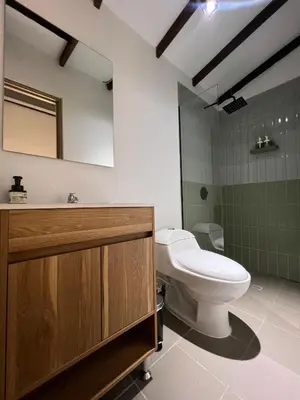 a bathroom with a toilet and a sink at Stylish 5-BR Apartment in Medellín's Trendiest Spot, Walk Everywhere! in Medellín