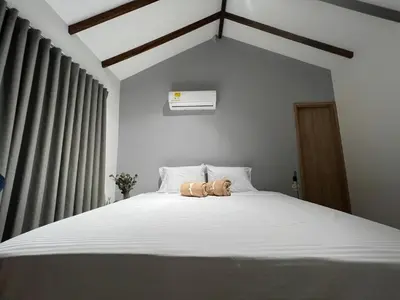a teddy bear sitting on top of a bed at Stylish 5-BR Apartment in Medellín's Trendiest Spot, Walk Everywhere! in Medellín
