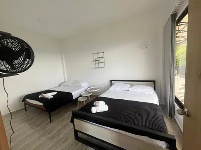 a bedroom with two beds and a fan at Curazao Natural Living in Cocorná