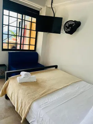 a bedroom with a bed with two towels on it at Curazao Natural Living in Cocorná