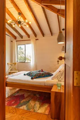 a bedroom with a bed in a room with a window at Organic Finca with Modern Amenities in Jericó