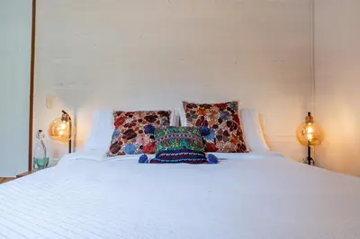 a teddy bear sitting on a bed with two lamps at Organic Finca with Modern Amenities in Jericó