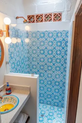 a bathroom with blue and white tiles on the wall at Organic Finca with Modern Amenities in Jericó