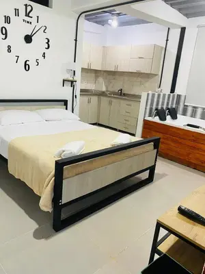 a bedroom with a bed and a large clock on the wall at Hotel Curazao Natural Living in Cocorná