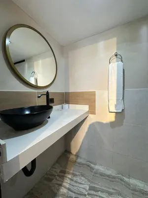 a bathroom with a black sink and a mirror at Hotel Coral Boutique in Medellín