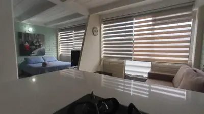 a living room with a table and a couch at ApartaLoft, Belén, Medellín in Medellín