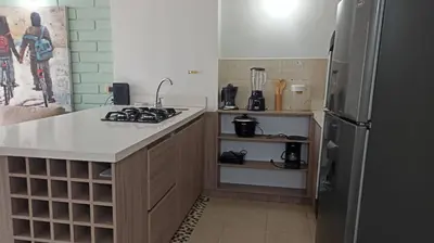 a kitchen with a stove and a refrigerator at ApartaLoft, Belén, Medellín in Medellín