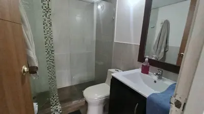 a bathroom with a toilet and a sink and a shower at ApartaLoft, Belén, Medellín in Medellín