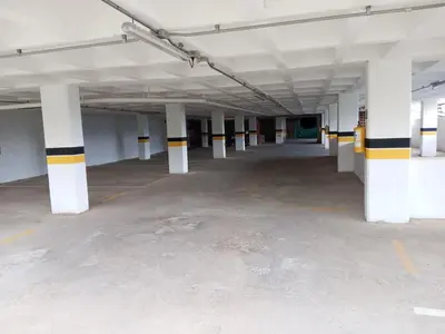 an empty parking lot with white columns in a parking garage at Casa Hotel Santa Laura Jericó in Jericó