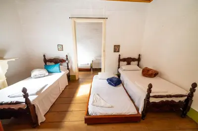 a room with two beds and a doorway at Casa Hotel Santa Laura Jericó in Jericó