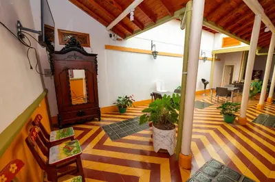 a large room with a wooden floor with plants in it at Casa Hotel Santa Laura Jericó in Jericó